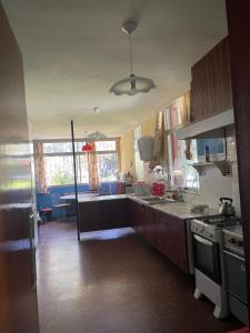 a kitchen with a sink and a stove at Chalet de Irurtia in Carmelo