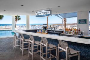 a bar at the beach with a view of the ocean at Best Western Premier - The Tides in Orange Beach