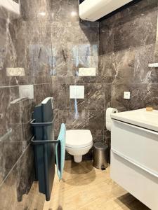 a bathroom with a toilet and a sink at Studette Cosy in Saint-James