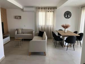 a living room with a couch and a table at Casa Dulcelina Monte Gordo, Algarve, Portugal in Monte Gordo