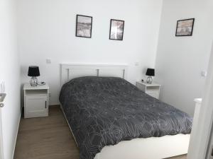 a white bedroom with a bed and three pictures on the wall at Casa Dulcelina Monte Gordo, Algarve, Portugal in Monte Gordo +7 photos