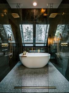 a bath tub in a bathroom with a window at Green Mountain Yay Frame in Killington