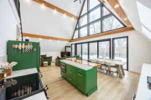 a kitchen with green cabinets and a large window at Green Mountain Yay Frame in Killington +43 photos