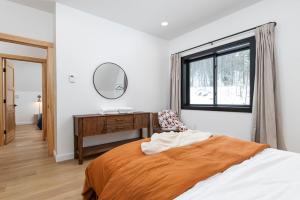 a bedroom with a bed and a desk and a window at Green Mountain Yay Frame in Killington