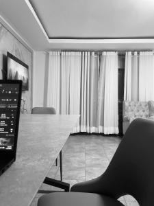 a room with a table and chairs and a couch at Kigali Legacy Villa Homes in Kigali