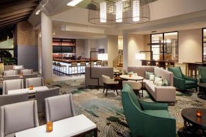 a hotel lobby with tables and chairs and a restaurant at DoubleTree by Hilton Manchester Downtown in Manchester