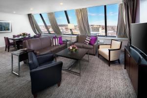 a living room with furniture and a large window at DoubleTree by Hilton Manchester Downtown in Manchester