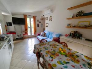 a kitchen and living room with a table and a couch at Soleluna in Levanto