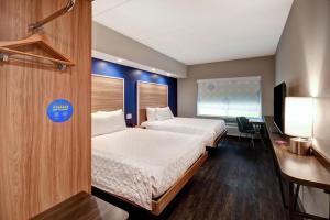 a hotel room with two beds and a desk at Tru By Hilton Raleigh Durham Airport in Morrisville +34 photos