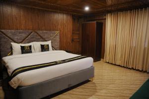a bedroom with a large bed in a room at The Barcelo Apartment & Cottages in Naran