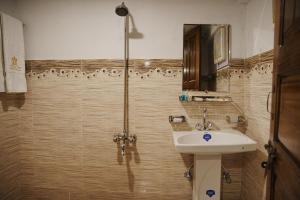 a bathroom with a shower and a sink at The Barcelo Apartment & Cottages in Naran