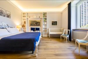 a bedroom with a bed and two chairs and a window at Mare e Monti in Genoa