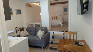 a living room with a couch and a table at Rivulet Nook in West Hobart