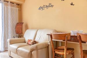 a living room with a couch and a table at La casetta in Marzio +16 photos