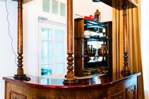 a wooden cabinet with a mirror on top of it at Officers Boutique Hotel in Samarkand