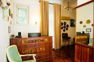 a room with a desk and a chair and a mirror at Officers Boutique Hotel in Samarkand