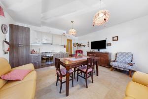 a kitchen and living room with a table and chairs at Tabià Padola in Padola