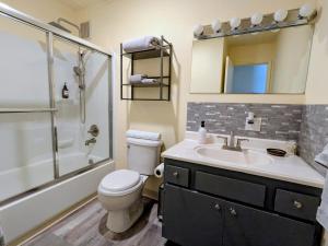 a bathroom with a toilet and a sink and a shower at Fireweed Apartments in Fairbanks +36 photos