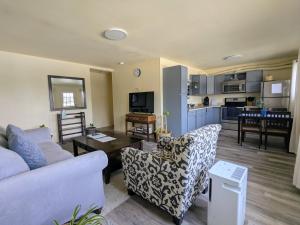 a living room with a couch and a table at Fireweed Apartments in Fairbanks