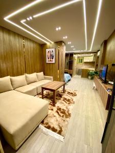 a living room with a couch and a table at Nile residence in Al Kawāmil Qiblī