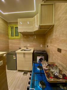 a kitchen with a blue counter top and a sink at Nile residence in Al Kawāmil Qiblī