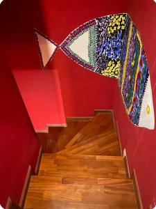 a staircase with a painting of a fish on the wall at Casa Roberta a due passi dal mare in Quartu Sant'Elena +16 photos