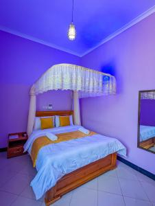 a bedroom with a bed with a canopy at New Harambee Hotel in Nakwa