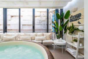 a hot tub in a room with a large window at Apartment Luxury Palace No1 in Split