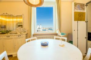 a dining room with a table and a window at Mare e Monti in Genoa