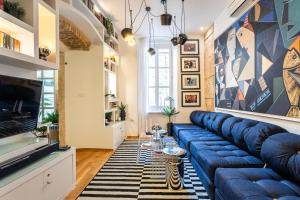 a living room with a blue couch and a tv at Apartment Luxury Palace No1 in Split