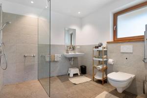 a bathroom with a shower and a toilet and a sink at Petrunderhof in Villnoss +83 photos