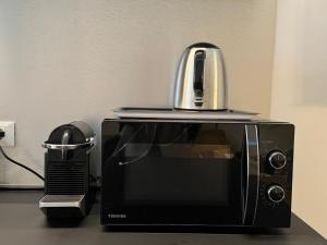 a microwave with a toaster sitting on top of it at Equi60 in Rome