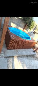 a wooden fence with a blue swimming pool at Tinajas martina in Las Cruces