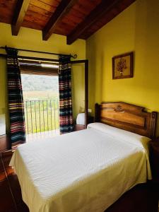 a bedroom with a white bed and a window at Cases Tonet in Forcall
