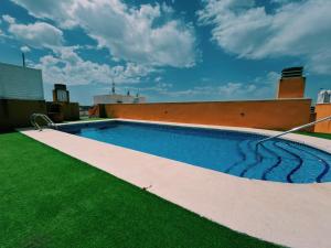 a swimming pool on the roof of a building at Casa de ogracia in Rojales