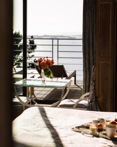 a table with a vase of flowers on a balcony at Manoir de Lan Kerellec - Relais & Châteaux - Etoilé Michelin in Trébeurden