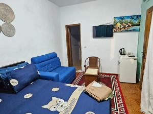 a small living room with a blue couch and a blue at Vince Saly in Saly Portudal