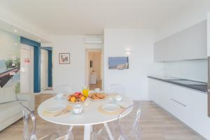 a white dining room with a white table and chairs at Valarin Residence & Villa Valarin Elite by Rent All Como in Vercana