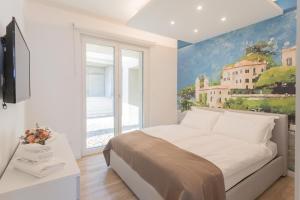a bedroom with a bed with a painting on the wall at Valarin Residence & Villa Valarin Elite by Rent All Como in Vercana
