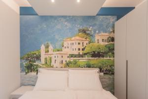 a bedroom with a painting on the wall at Valarin Residence & Villa Valarin Elite by Rent All Como in Vercana