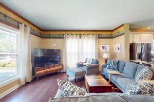 a living room with a couch and a tv at Anchors Aweigh in Edgewater