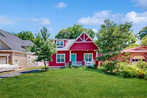 a red house with a yard at Anchors Aweigh in Edgewater