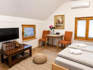 a living room with two beds and a tv at Airport Studio Loft - Galleria in Belgrade