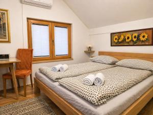 a bedroom with a bed with towels on it at Airport Studio Loft - Galleria in Belgrade