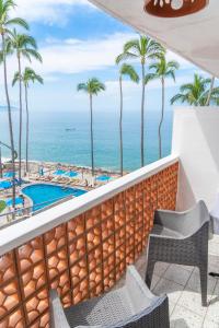 a view of the ocean from the balcony of a resort at Hotel Rosita in Puerto Vallarta