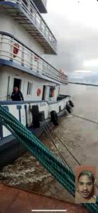 a man standing on the deck of a ship at Praia dos sonhos 123 in Diadema