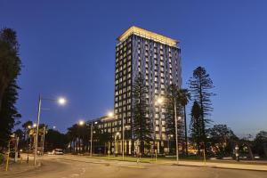 a tall building on a city street at night at Doubletree By Hilton Perth Waterfront in Perth