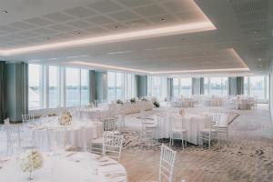 a banquet hall with white tables and chairs at Doubletree By Hilton Perth Waterfront in Perth +103 photos