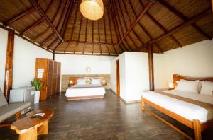a bedroom with two beds and a table in a room at Riosol Laguna Azul in Sauce
