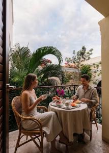 a man and a woman sitting at a table at La Casa del Centro, Mérida by Cercana in Mérida